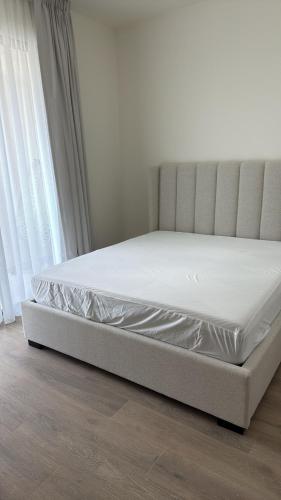 a bed sitting in a room next to a window at Noya Viva villa in Abu Dhabi