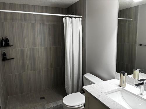 a bathroom with a shower and a toilet and a sink at Nature Home Near Downtown and 17th Avenue in Calgary