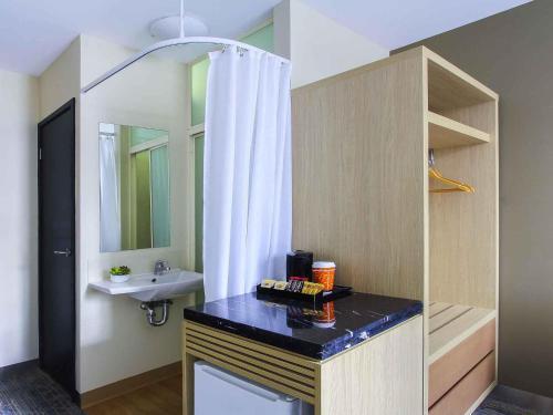 a bathroom with a sink and a shower curtain at ibis Budget - Melbourne CBD in Melbourne