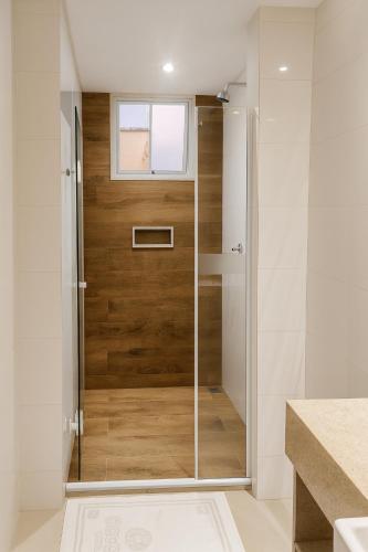 a shower with a glass door in a bathroom at Center Hotel in Duque de Caxias