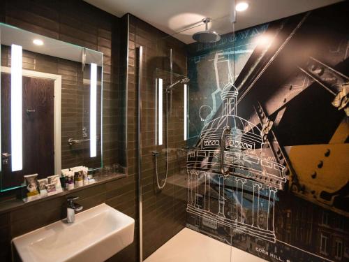 a bathroom with a sink and a shower with a mural at Mercure Bridgwater in Bridgwater