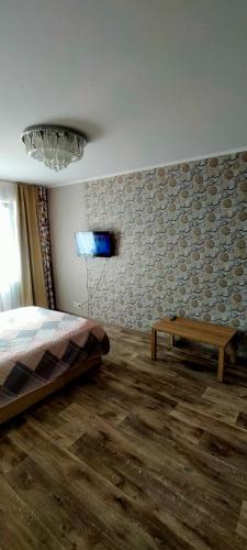 une chambre avec un lit et une table dedans dans l'établissement Рахмет, à Petropavlovsk-Kamtchatski