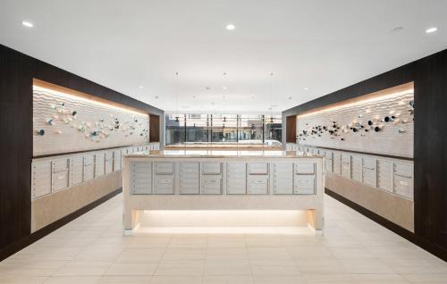 a lobby with a counter with birds on the wall at Hyatus Luxury Residences Boston Everett Premier Collection in Everett