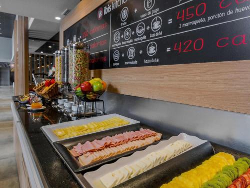 a buffet line with different types of food on display at ibis Iquique in Iquique