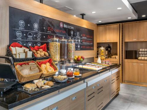 a bakery with bread and other food on a counter at ibis Iquique in Iquique