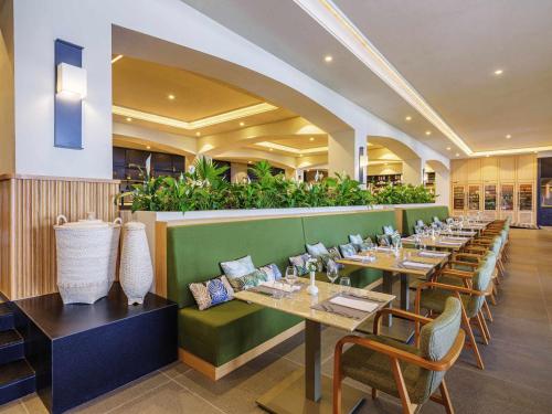 a dining room with long tables and chairs at Rixos Premium Bodrum in Torba