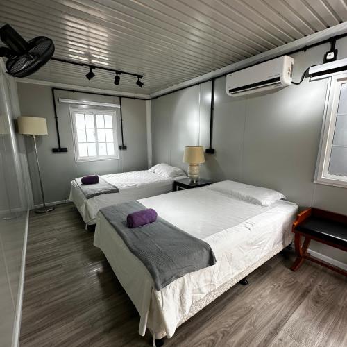 a bedroom with two beds and a fan at Orchid Cabin Kuala Tahan in Kuala Tahan