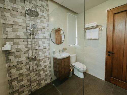 a bathroom with a toilet and a sink and a shower at Nusari Villa Ubud in Ubud