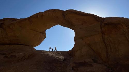 two people standing on top of a rock formation at Wadi Rum Desert Life in Wadi Rum