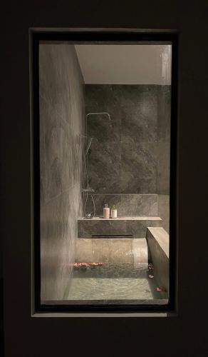 a picture of a bathroom with a shower and a tub at 1818 UVA in Bandarawela