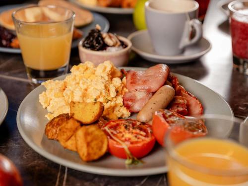 a plate of breakfast food on a table at Novotel Brisbane South Bank in Brisbane