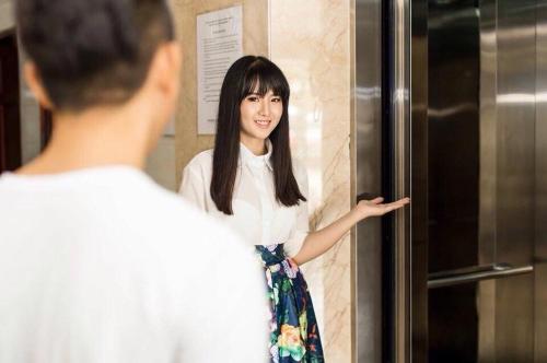 a woman standing in front of a mirror at Hà Tiên Hạnh Phúc Hotel in Ha Tien