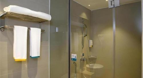 a bathroom with a shower and a glass shower stall at City Comfort Inn Shenzhen International Exhibition Center Tangwei Metro Station in Fenghuangwei