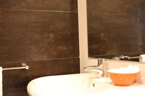 a bathroom with a sink and a black wall at Hotel Pontes do Eume in Puentes de García Rodríguez