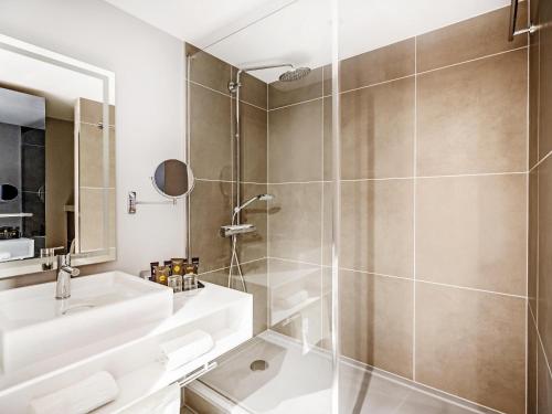 a bathroom with a shower and a sink at Novotel Leicester in Leicester