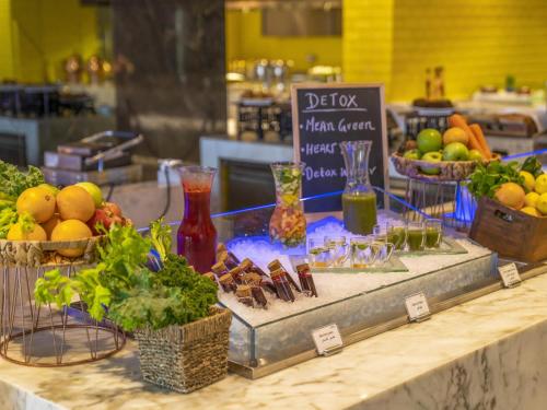 a display of fruits and vegetables in baskets on a counter at Pullman Sharjah in Sharjah