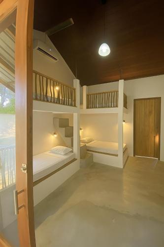 a room with two bunk beds and a door at Jungle Trails in Sigiriya