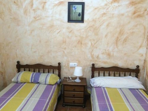 Postel nebo postele na pokoji v ubytování Casas y Cuevas El Solins