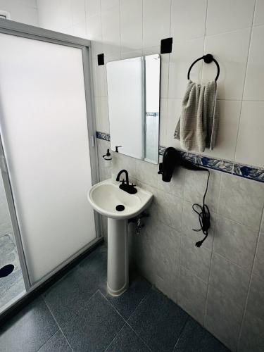 a bathroom with a sink and a mirror at DCalli Next to the Alameda, terrace and confort in Orizaba
