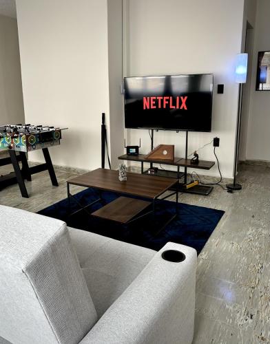 a living room with a couch and a television at DCalli Next to the Alameda, terrace and confort in Orizaba