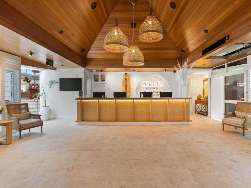 a lobby with a reception desk and chairs at BreakFree Aanuka Beach Resort in Coffs Harbour
