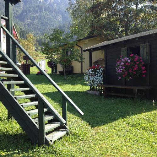 a staircase leading to a house with flowers in a yard at Kapriol in Castello Tesino