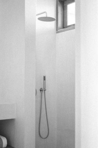 a shower in a bathroom with a shower head at Teddies in Ahangama