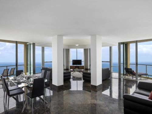 a living room with a view of the ocean at Mantra Sun City in Gold Coast