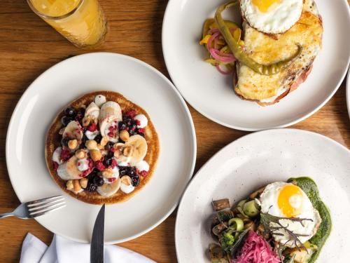 a table topped with plates of breakfast foods at Peppers Silo Launceston in Launceston