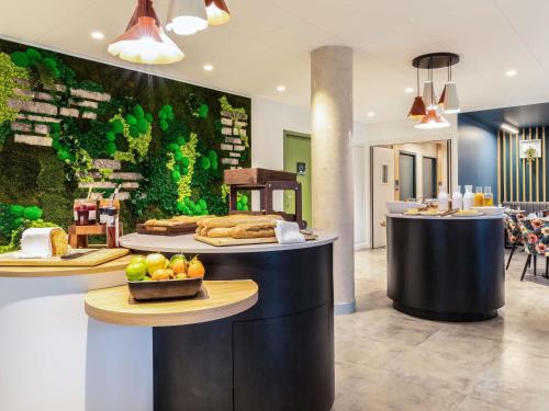 Un restaurante con un buffet de comida en exhibición. en ibis Styles Bezons Paris La Défense, en Bezons