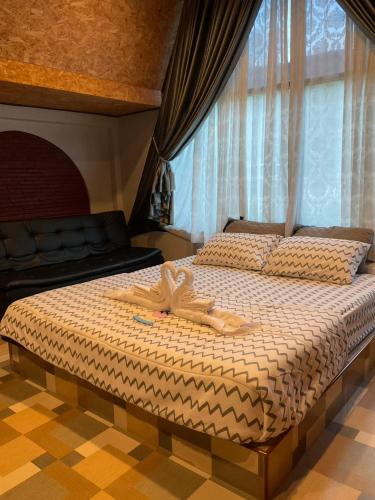 a bedroom with a bed with two pairs of shoes on it at Mountain Deer Resort & Camping in Ban Mung