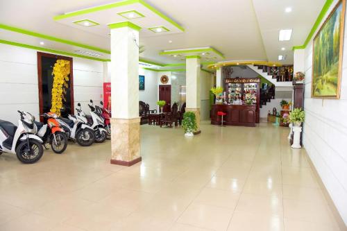 a lobby with motorcycles parked in a building at Thanh Tùng Hotel in Can Tho