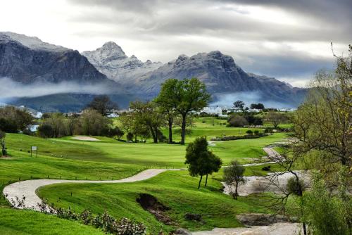 a golf course with mountains in the background at De Zalze Lodge in Stellenbosch