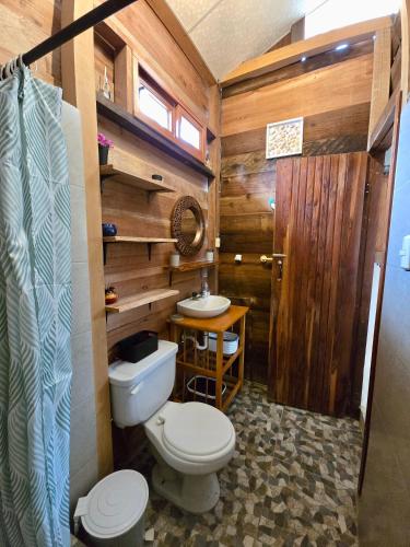 a bathroom with a toilet and a sink at La posada de Mary in Montañita