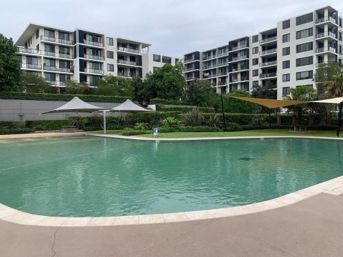 an empty swimming pool in front of some apartment buildings at Waterfront High Rise 5 Beds 2 Car Parks in Sydney