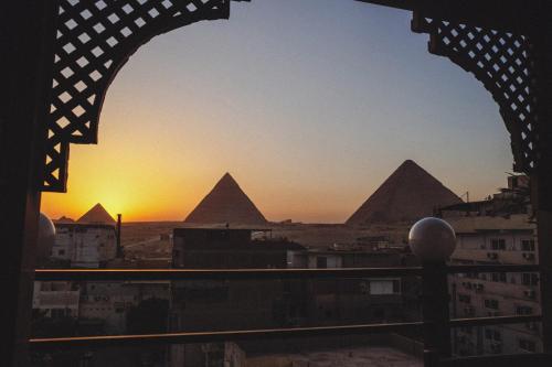 a view of the pyramids from a window of a building at Jimmy Pyramids Hotel in Cairo