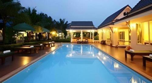 a large swimming pool in front of a house at The Forest Home Resort in Ban Dong