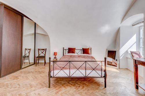 a bedroom with a bed and two chairs at Studio Nicolas Prague in Prague