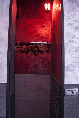 a bathroom with a red wall and a red light at Hotel Agorà in Rome