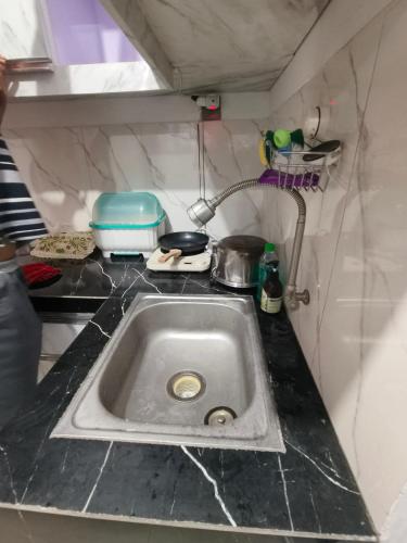 a kitchen counter with a sink in a kitchen at Kira Villa in Tlekung