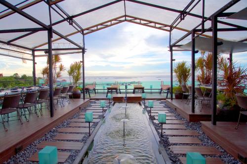 a patio with a pool and tables and chairs at Kroque Boutique & Bistro in Ang Sila