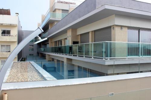 an external view of a building with a swimming pool at Apartamentos Turisticos da Nazare in Nazaré
