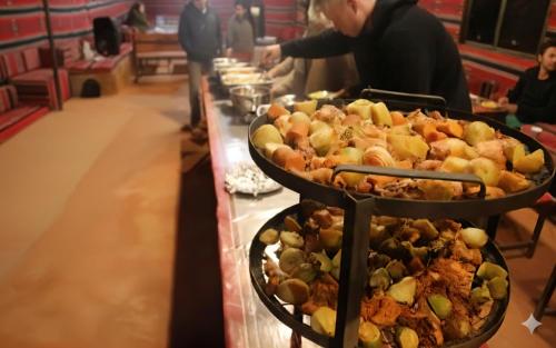 a buffet line with several trays of food at Golden Day Bedouin Camp in Wadi Rum