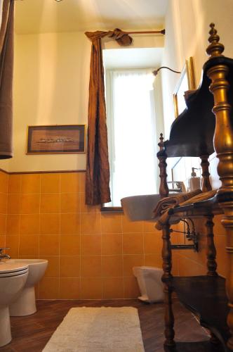 a bathroom with a toilet and a window at Le Macine Relais in Cairo Montenotte