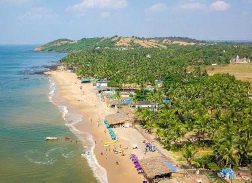 an aerial view of a beach with people on it at Noah's Yacht Farm in Siolim