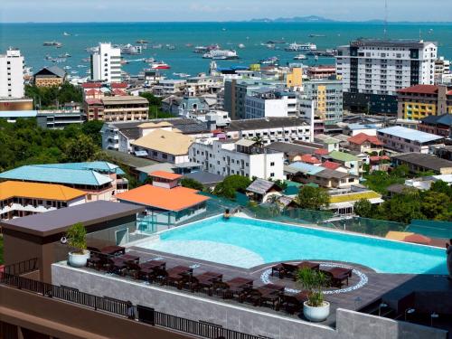 an aerial view of a city with a swimming pool at Samsara Hotel Pattaya in Pattaya South