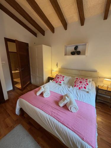a bedroom with a large bed with towels on it at Nispero in Sa Pobla