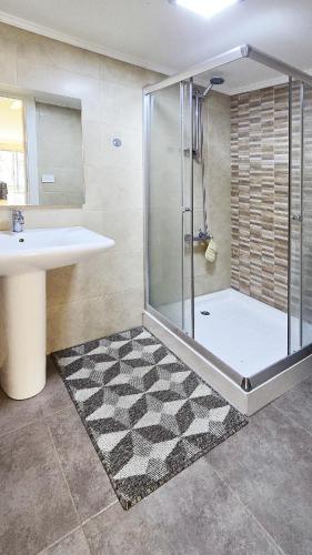 a bathroom with a shower and a sink at Tabarja Heights in ‘Ayn aş Şughayrah