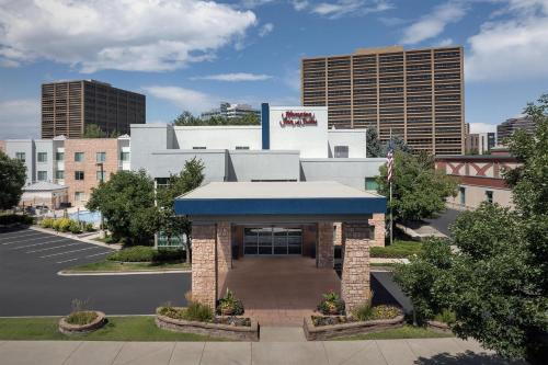a building with a blue awning in a parking lot at Hampton Inn & Suites Denver Tech Center in Centennial