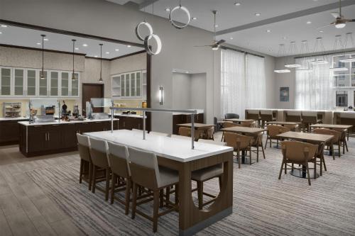 a restaurant with tables and chairs in a cafeteria at Homewood Suites by Hilton Concord in Concord
